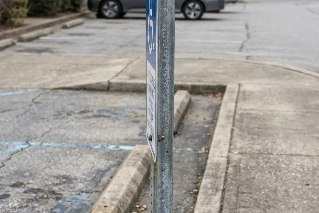 An accessible parking sign mounted at the required height on a post