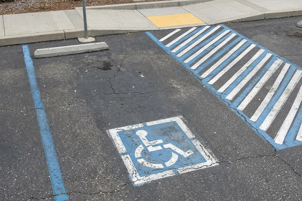 An accessible parking stall with its hatched access aisle and sign