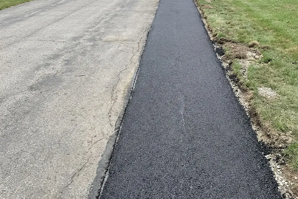 A new asphalt strip added alongside an existing Edmonton driveway