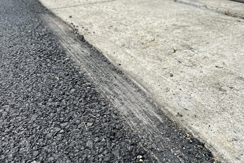 An overlay edge milled down so the new level meets the garage apron